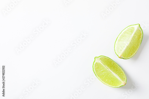 Fresh limes on white background, space for text