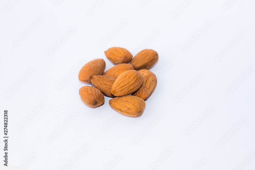 close up of brown almonds seeds isolated on white background close up of brown almonds seeds isolated on white background