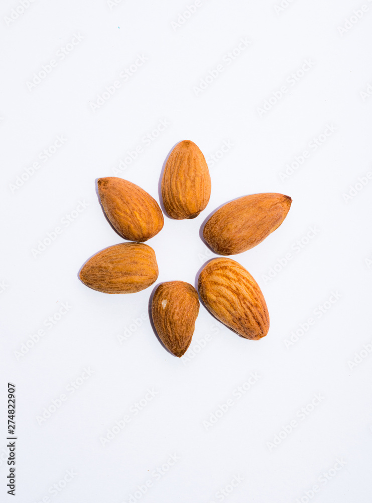 close up of brown almonds seeds isolated on white background close up of brown almonds seeds isolated on white background