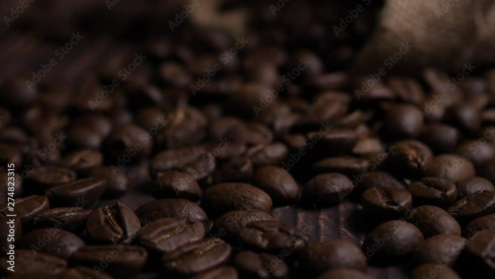 Slow motion 180 FPS Brown roasted coffee beans falling on pile Slow motion 180 FPS Brown roasted coffee beans falling on pile