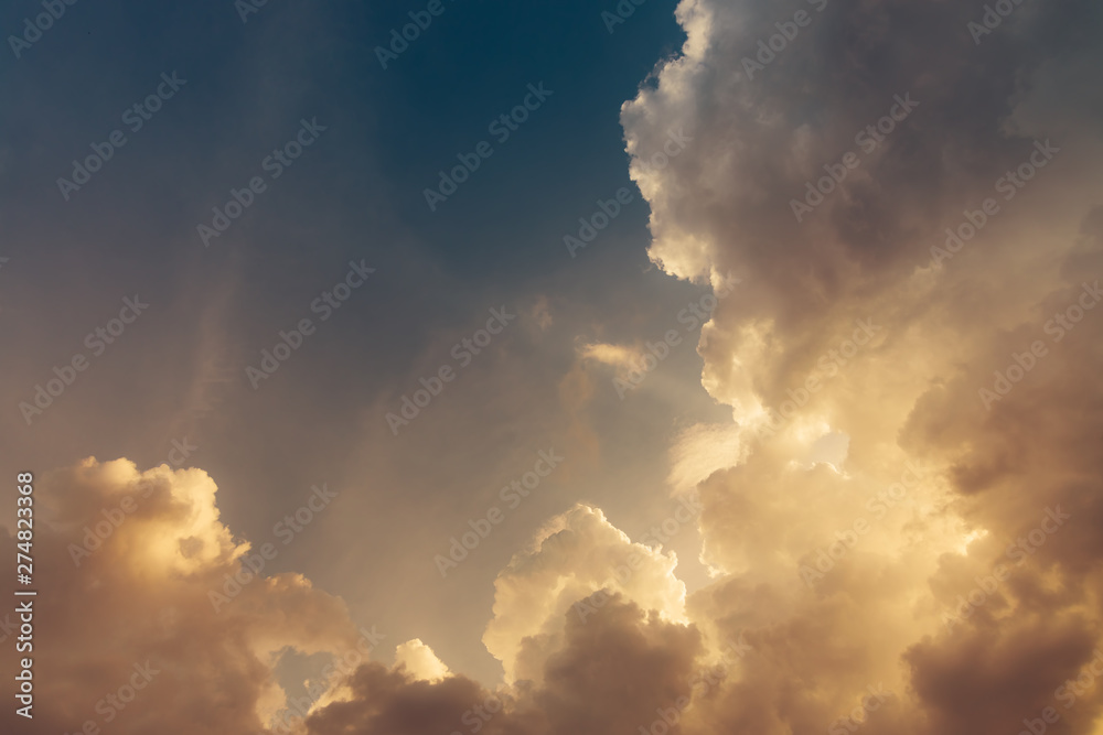 Yellow saturated cumulus clouds at sunset and blue sky, copy space Yellow saturated cumulus clouds at sunset and blue sky, copy space