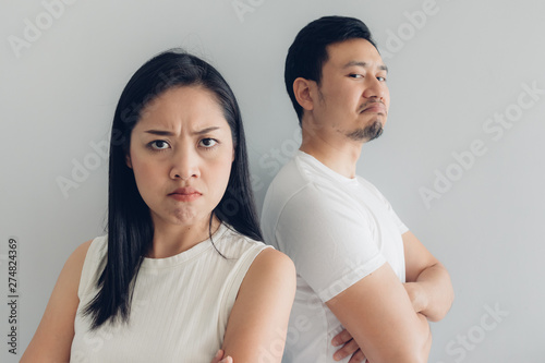 Angry couple lover in white t-shirt and grey background.
