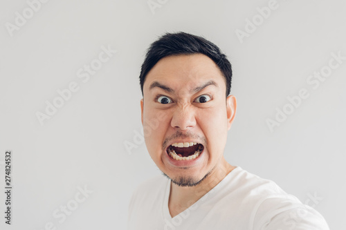 Close up face of angry man selfie himself.