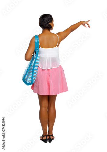 Back view of an afro american woman with an inflatable circle which points hand up. © ghoststone
