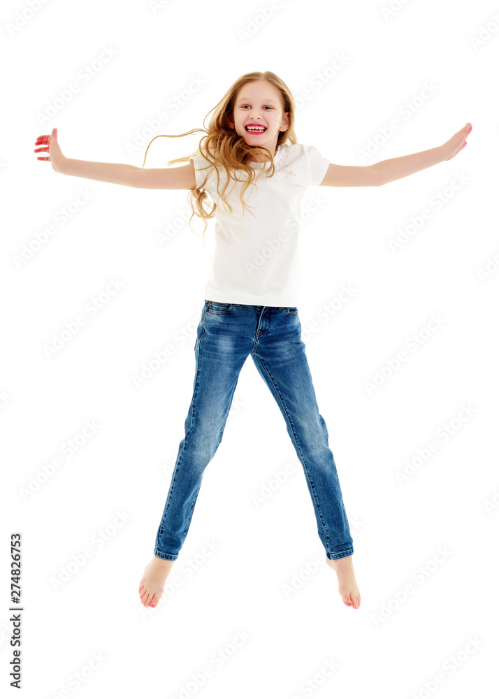 A little girl in a pure white t-shirt is jumping. The concept of A little girl in a pure white t-shirt is jumping. The concept of