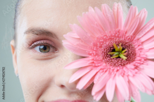 Wallpaper Mural Beautiful face of young smiling woman and pink flower Torontodigital.ca