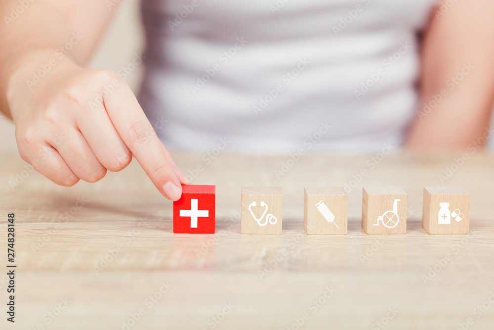 Obraz premium Health Insurance Concept,hand arranging wood block stacking with icon healthcare medical.