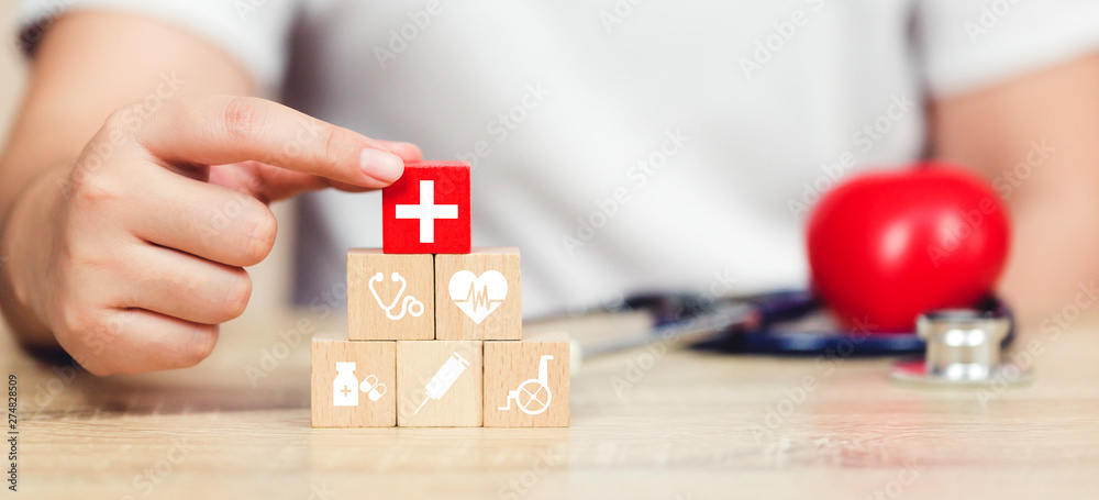 Obraz premium Health Insurance Concept,hand arranging wood block stacking with icon healthcare medical.