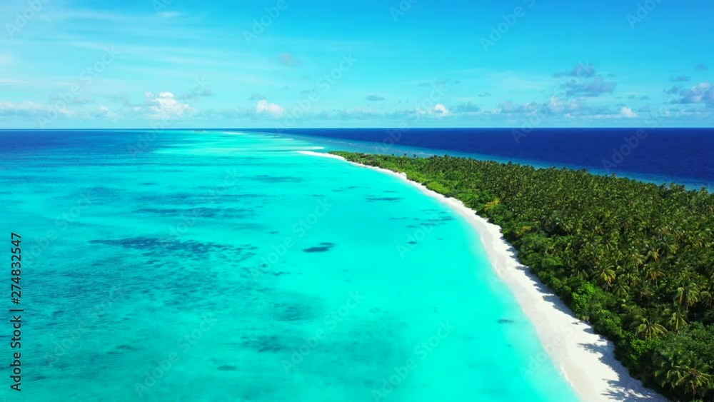 Aerial view of a flight above a tropical island with trees on it. In the turquoise blue sea in Bali. Dolly out. Aerial view of a flight above a tropical island with trees on it. In the turquoise blue sea in Bali. Dolly out.