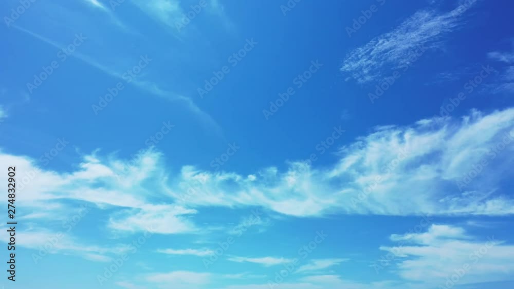 A blue summer sky with clouds above the deep blue Philippine Sea. pan right, wide angle.