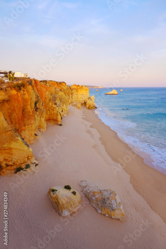 View on the beach Careanosy in Portimao with beautiful cliffs on the sunset. Vacation in Portugal. photo