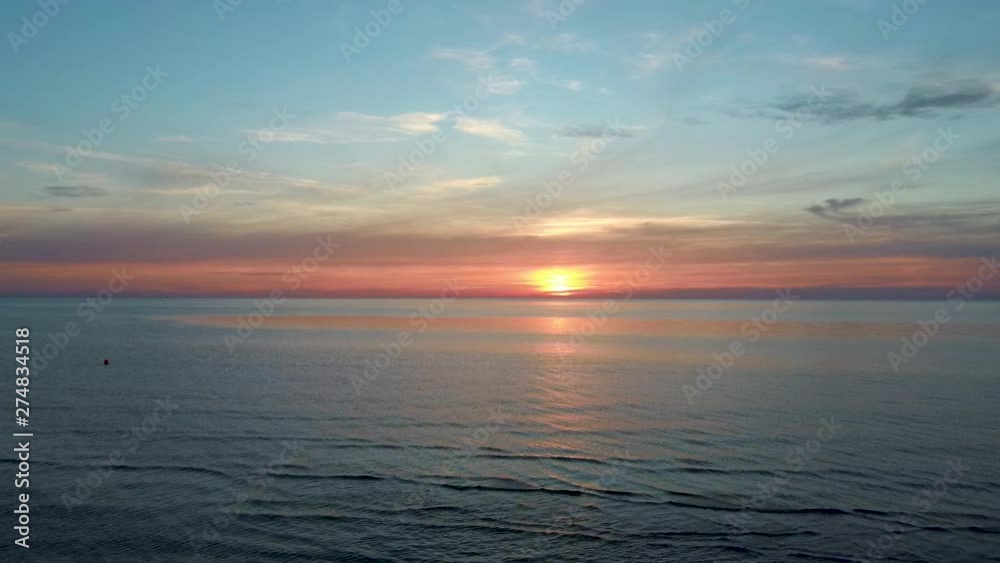 Dron Flying Over Sea in a Beautiful Sunset. Beautiful Sea Sunset Flyover Aerial Drone Shoot. Sunrise Over the Sea. Colorful Sunset on the Baltic Sea, Latvia Dron Flying Over Sea in a Beautiful Sunset. Beautiful Sea Sunset Flyover Aerial Drone Shoot. Sunrise Over the Sea. Colorful Sunset on the Baltic Sea, Latvia