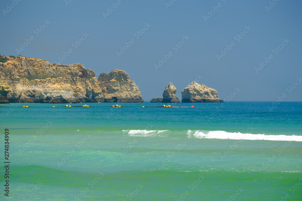View on the beach Alvor Poente with beautiful cliffs in Algarve, Portugal.