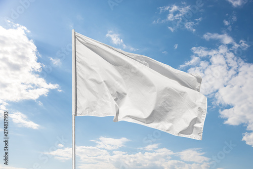 White flag against the blue sky