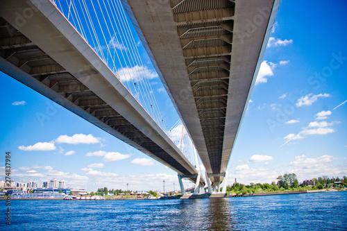 concrete bridge over the river against the blue sky