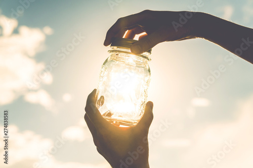 concept to catch your happiness. concept of leaving summer. the sun in the hands of the girl.