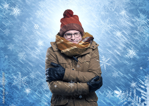 Gorgeous boy wearing warm clothing and freezing in cool snowy  concept
 photo