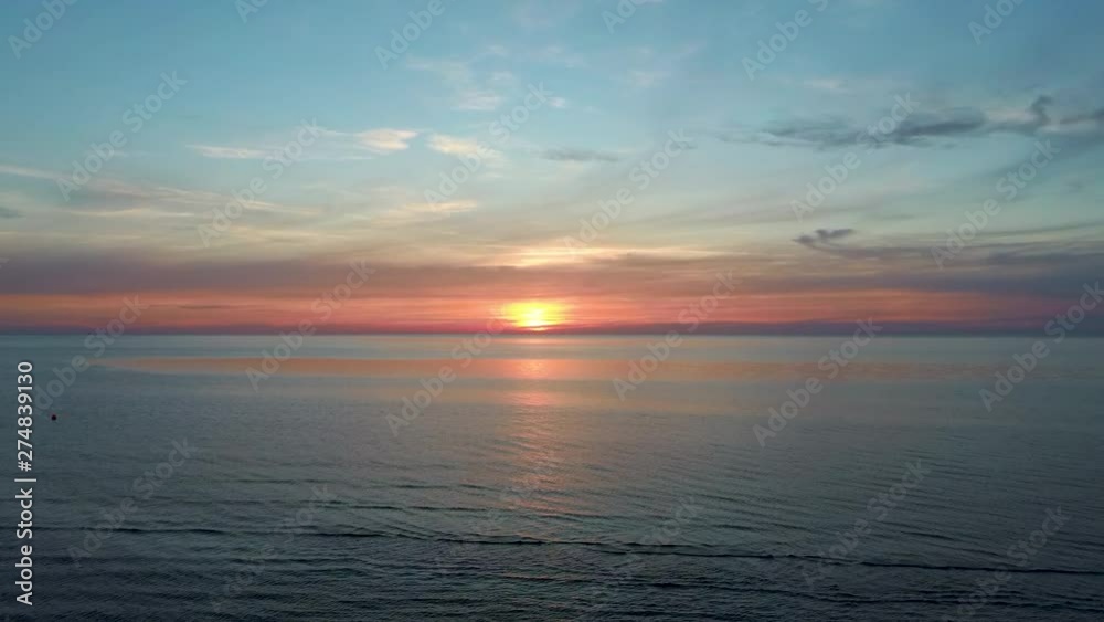 Dron Flying Over Sea in a Beautiful Sunset. Beautiful Sea Sunset Flyover Aerial Drone Shoot. Sunrise Over the Sea. Colorful Sunset on the Baltic Sea, Latvia Dron Flying Over Sea in a Beautiful Sunset. Beautiful Sea Sunset Flyover Aerial Drone Shoot. Sunrise Over the Sea. Colorful Sunset on the Baltic Sea, Latvia