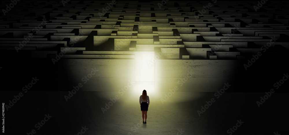 Woman getting ready to enter the dark labyrinth with illuminated door
Woman getting ready to enter the dark labyrinth with illuminated door