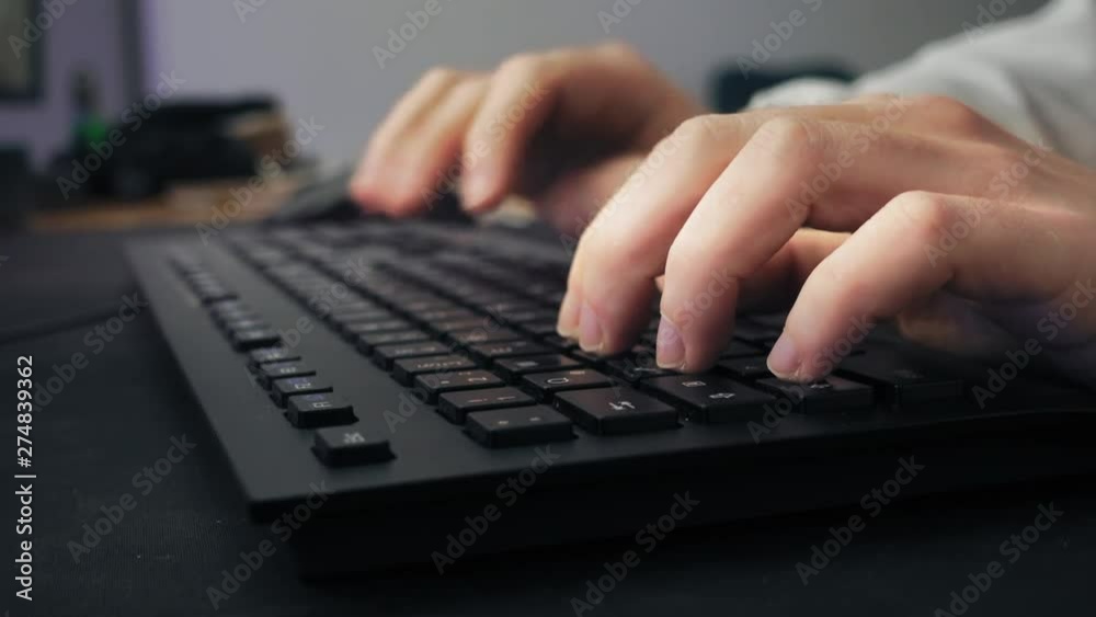 Closeup of a male gamer writing on the keyboard Closeup of a male gamer writing on the keyboard