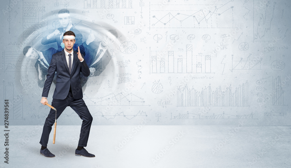 Young businessman in suit fighting with chart and report concept
Young businessman in suit fighting with chart and report concept