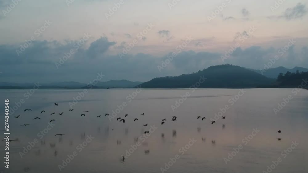 Drone aerial view of natural reservoir with bordering mountains located in Chantaburi province, Thailand. Drone aerial view of natural reservoir with bordering mountains located in Chantaburi province, Thailand.