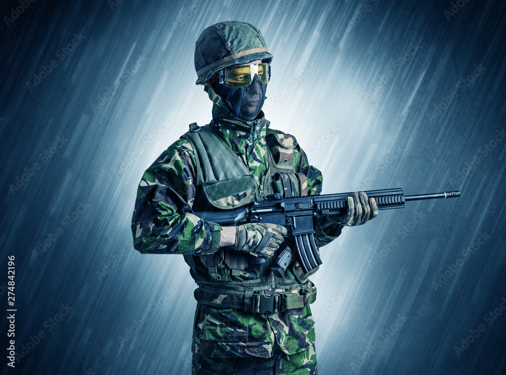 Armed soldier standing in rainy weather
Armed soldier standing in rainy weather
