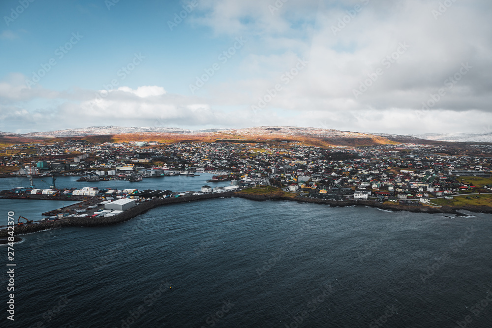 Aerial shot of the town Torshavn and its harbour as taken during a helicopter flight on an early spring morning  (Faroe Islands, Denmark, Europe)