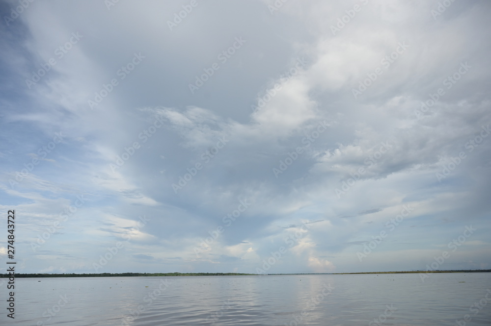 Stormy clouds forming above the Amazon river in the Peruvian rain forest Stormy clouds forming above the Amazon river in the Peruvian rain forest