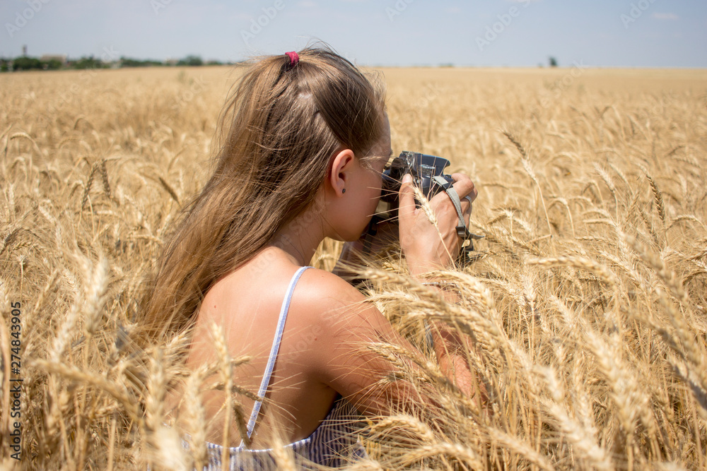 woman taking pictures of a wheat field woman taking pictures of a wheat field
