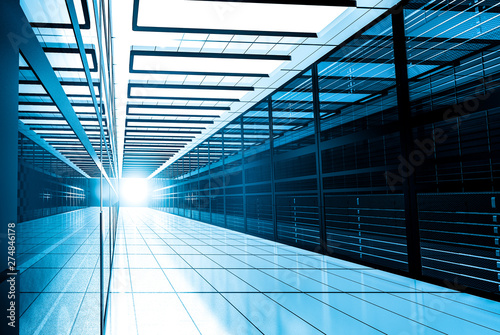 Modern web network and internet telecommunication technology, big data storage and cloud computing computer service business concept: server room interior in datacenter in blue light. 3D render
