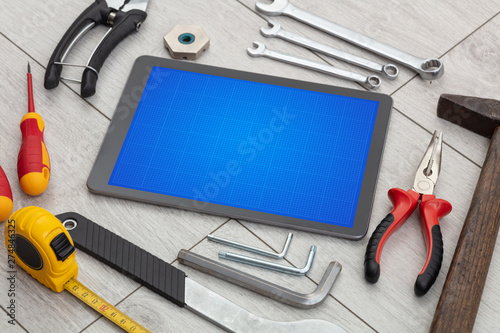 Household tools and tablet with grid screen concept
