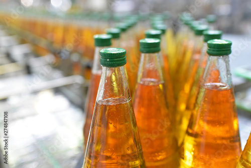 Fotografía befüllen von Glasflaschen auf dem Fliessband mit Apfelsaft in der industriellen