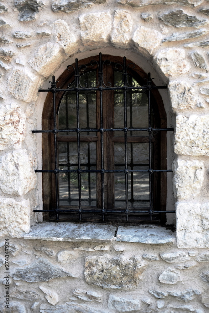 old wooden window in stone wall