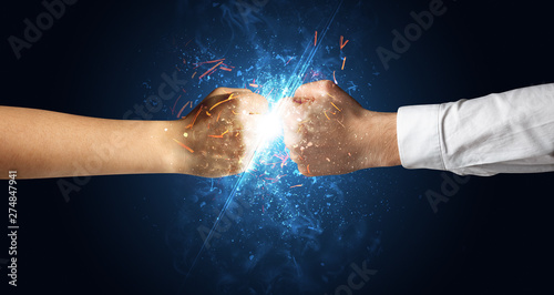 Two hands fighting with light, glow, spark and smoke concept 