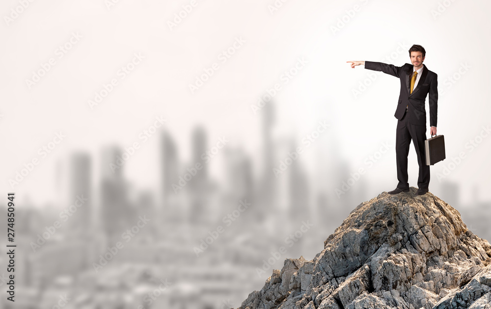 Young business person looking to the city from distance
Young business person looking to the city from distance