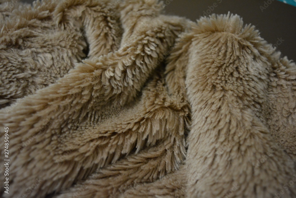 Soft coffee synthetic fabric in the form of natural long fur. Brown synthetic fur in spacing arrangement with different structure and shape. Soft coffee synthetic fabric in the form of natural long fur. Brown synthetic fur in spacing arrangement with different structure and shape.