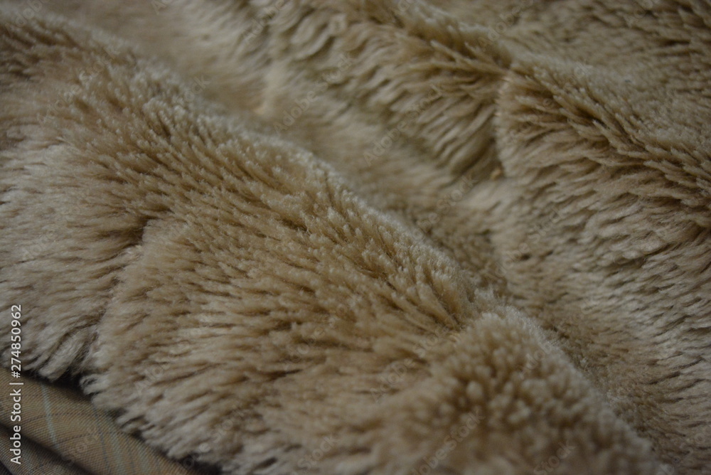 Soft coffee synthetic fabric in the form of natural long fur. Brown synthetic fur in spacing arrangement with different structure and shape. Soft coffee synthetic fabric in the form of natural long fur. Brown synthetic fur in spacing arrangement with different structure and shape.