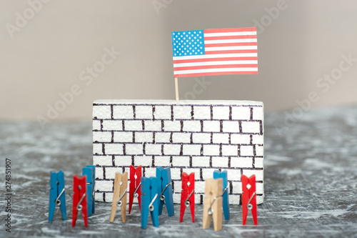 imitation of people against a wall border, bricks on white with an American flag