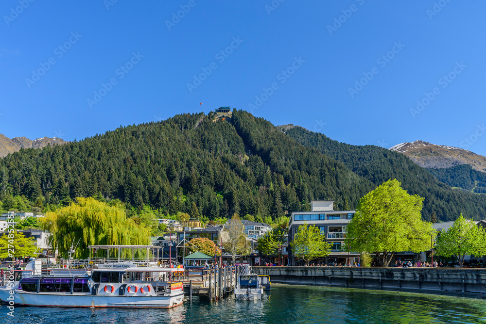 QUEENSTOWN, NEW ZEALAND - OCTOBER 10, 2018: View of the city embankment. Copy space for text. QUEENSTOWN, NEW ZEALAND - OCTOBER 10, 2018: View of the city embankment. Copy space for text.