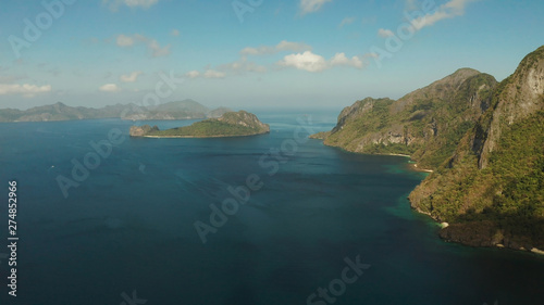 Seascape with tropical bay  rocky islands  ocean blue water  aerial view. islands and mountains covered with tropical forest. El nido  Philippines  Palawan. Tropical Mountain Range