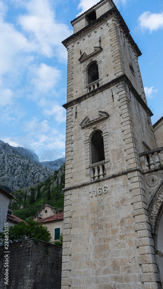 Old church inside Stari Grad, Kotor, Montenegro. Kotor bay and Old Town from Lovcen Mountain. Montenegro. Tower with mountains in the background