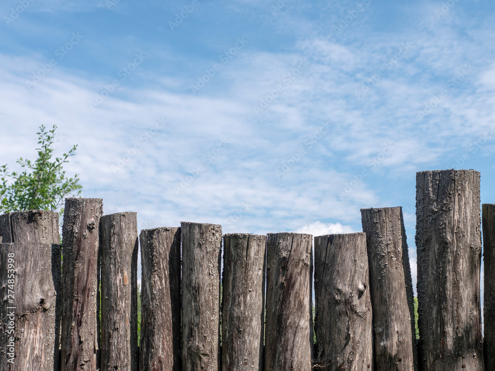 Wooden fence against the blue sky