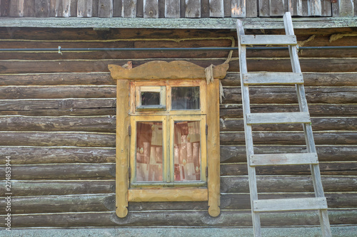 Wall of a wooden country house with a window