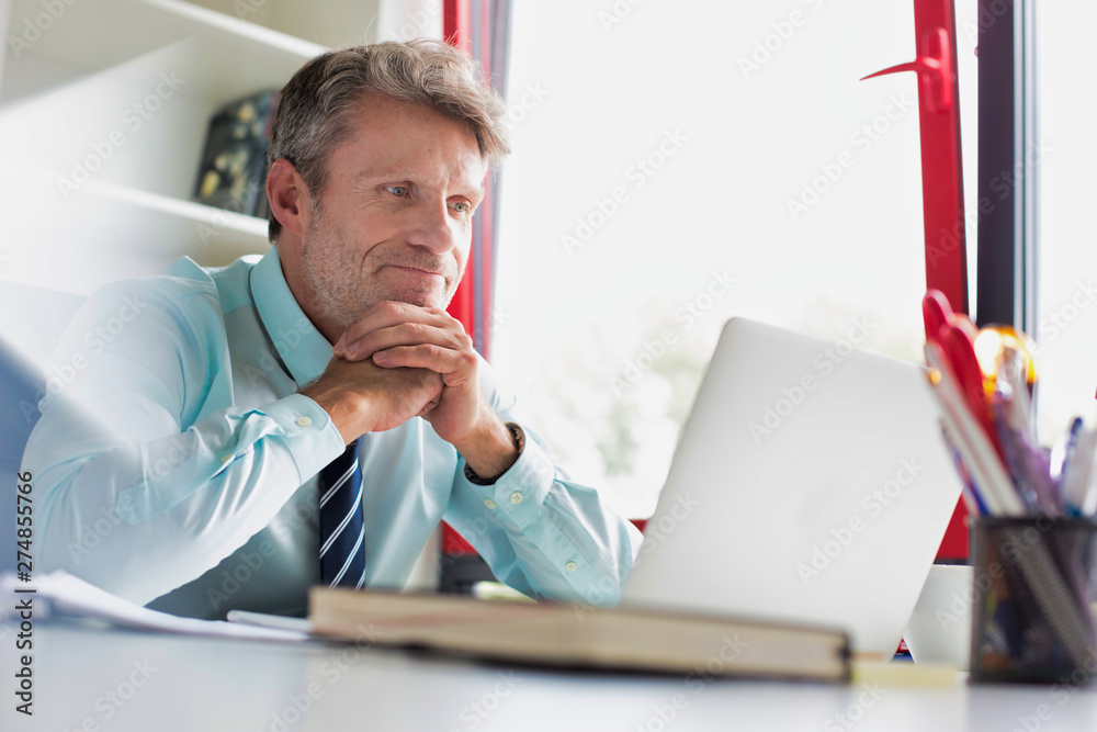 Fototapeta premium Senior business man taking an internet conferene call and looking glum