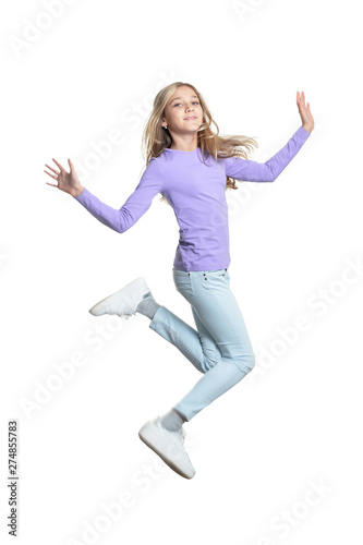 Portrait of cute little girl jumping isolated