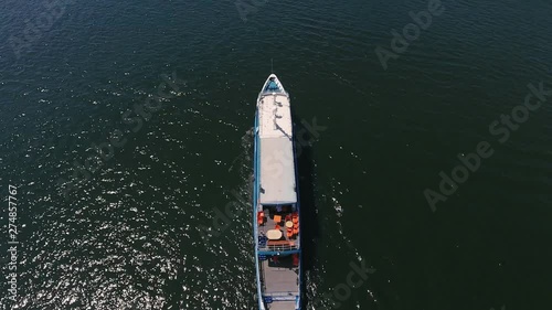 Aerial shot of a cargo barge moving in the Dnipro on a sunny day in summer   photo