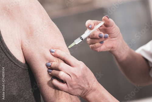 Doctor injecting vaccine to patient © thodonal