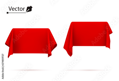 Object covered with red silk cloth. Box, rectangle. Surprise, award, prize, presentation concept. Reveal a hidden object. 