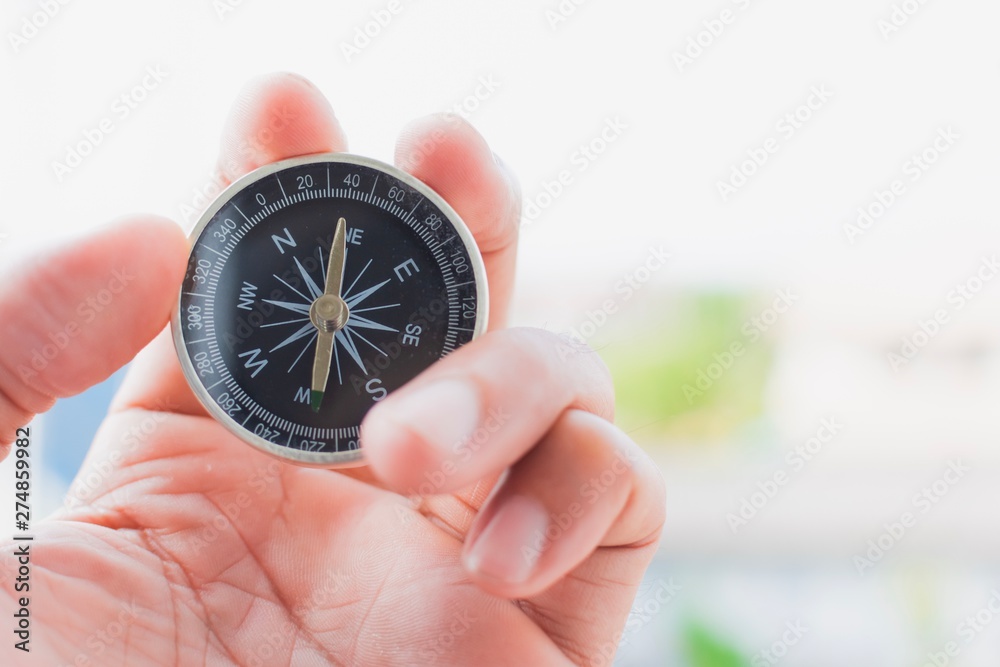 man holding compass on blurred background. for activity lifestyle man holding compass on blurred background. for activity lifestyle